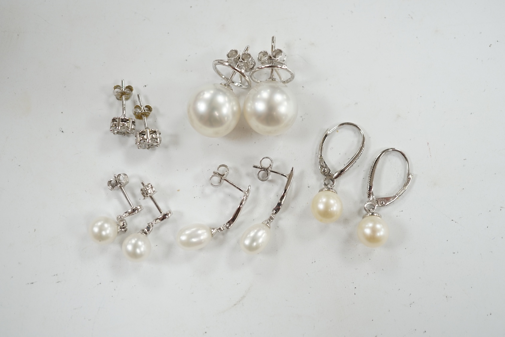 Three assorted modern pairs of 9ct, cultured pearl and diamond chip set earrings, a similar diamond cluster pair and a pair of cultured pearl earrings. Condition - fair to good